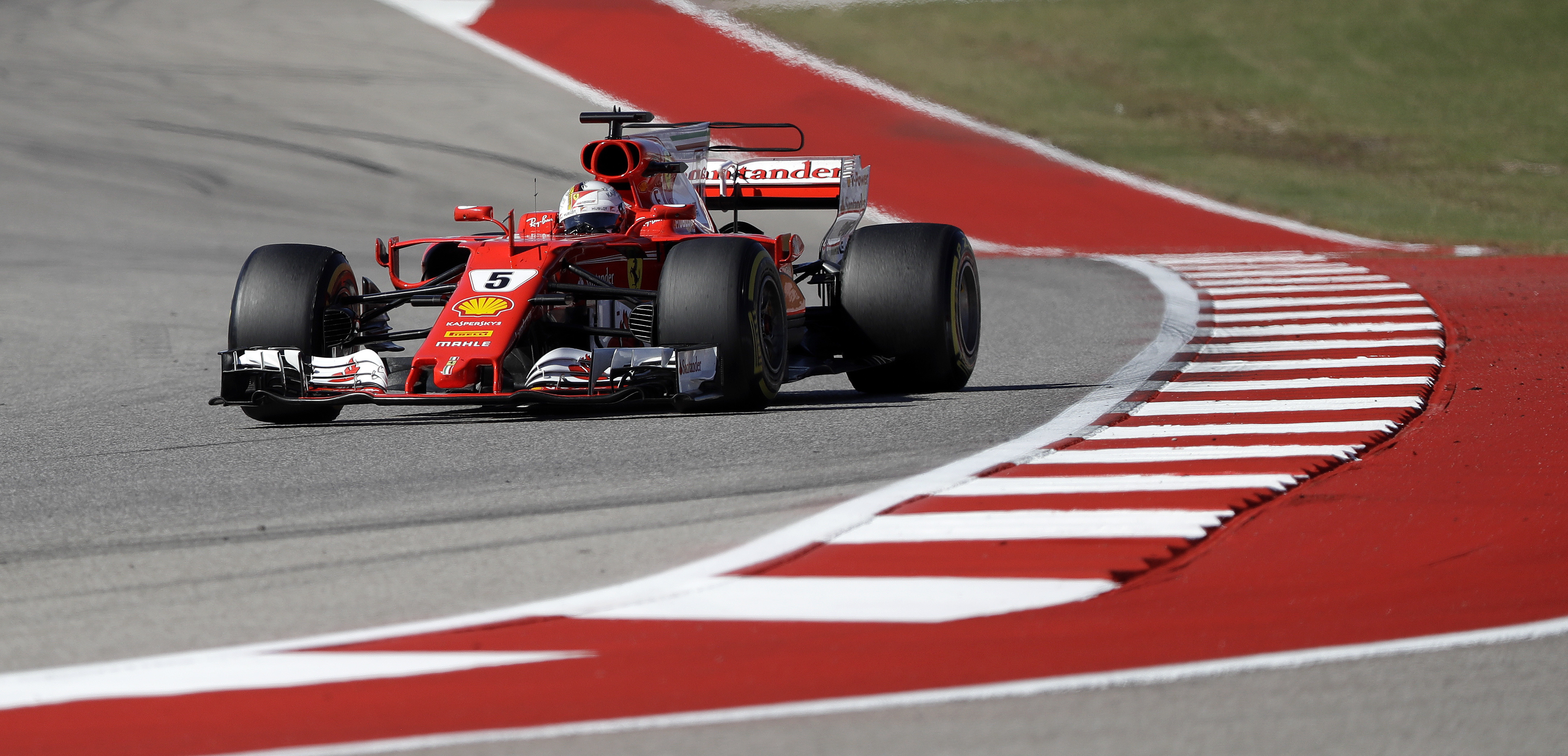 Ferrari driver Sebastian Vettel, of Germany, comes through a turn during the Formula One U.S. Grand Prix auto race at the Circuit of the Americas- AP